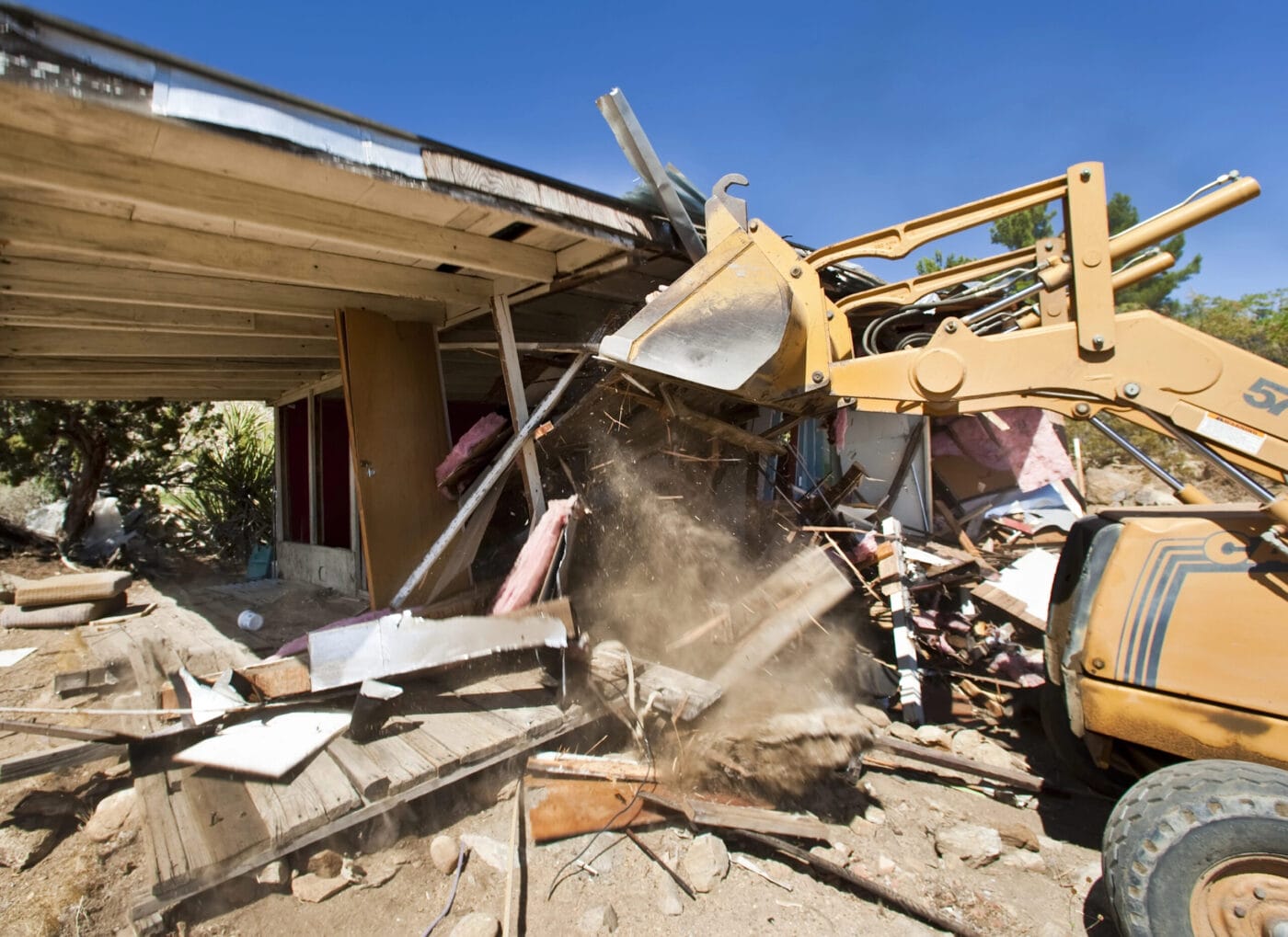 House being destroyed by bull dozer